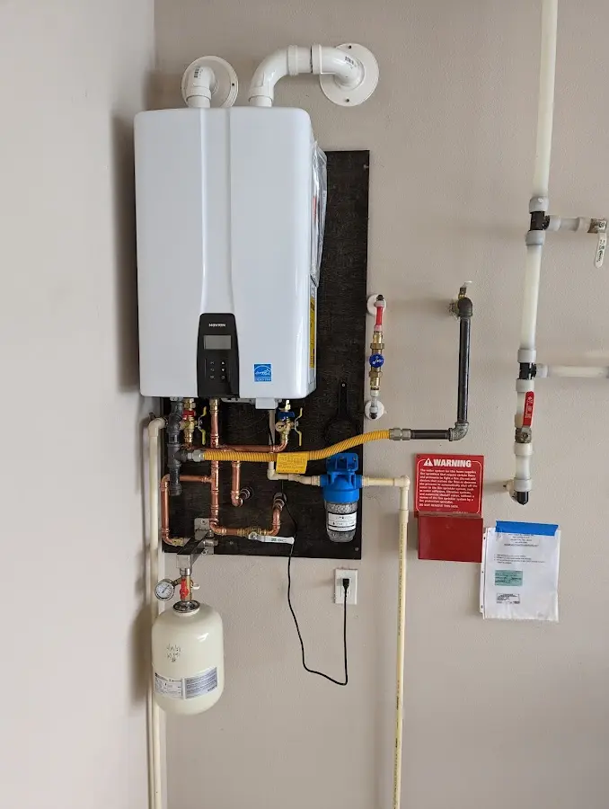 Professional plumber installing copper piping in a Waipio home